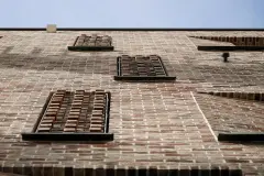 Bathroom windows feature a perforated brick detail that cleverly blends into the surrounding facade whilst protecting residents' privacy, yet still allowing daylight in.