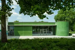 Green glass mosaic facade on extension of sports centre in Heidelburg, Germany completed in 2014