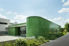 Green glass mosaic facade on extension of sports centre in Heidelburg, Germany completed in 2014