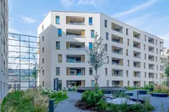 The internal courtyard of the Stadt Carre complex in Innsbruck features shared green space and children's playgrounds