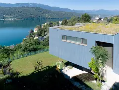 Villa Mimi at Lake Millstatt cantilevers over a hillside, finished with blue glass mosaic tiles