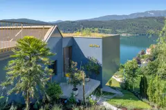 Villa Mimi at Lake Millstatt cantilevers over a hillside, finished with blue glass mosaic tiles