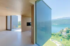 Villa Mimi at Lake Millstatt cantilevers over a hillside, finished with blue glass mosaic tiles