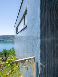 Villa Mimi at Lake Millstatt cantilevers over a hillside, finished with blue glass mosaic tiles