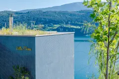 Villa Mimi at Lake Millstatt cantilevers over a hillside, finished with blue glass mosaic tiles