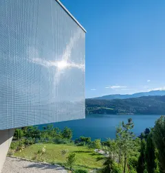 Villa Mimi at Lake Millstatt cantilevers over a hillside, finished with blue glass mosaic tiles