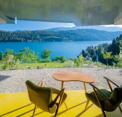 Villa Mimi at Lake Millstatt cantilevers over a hillside, finished with blue glass mosaic tiles