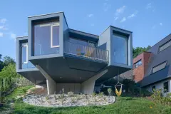 Villa Mimi at Lake Millstatt cantilevers over a hillside, finished with blue glass mosaic tiles