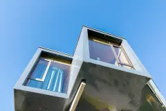 Villa Mimi at Lake Millstatt cantilevers over a hillside, finished with blue glass mosaic tiles